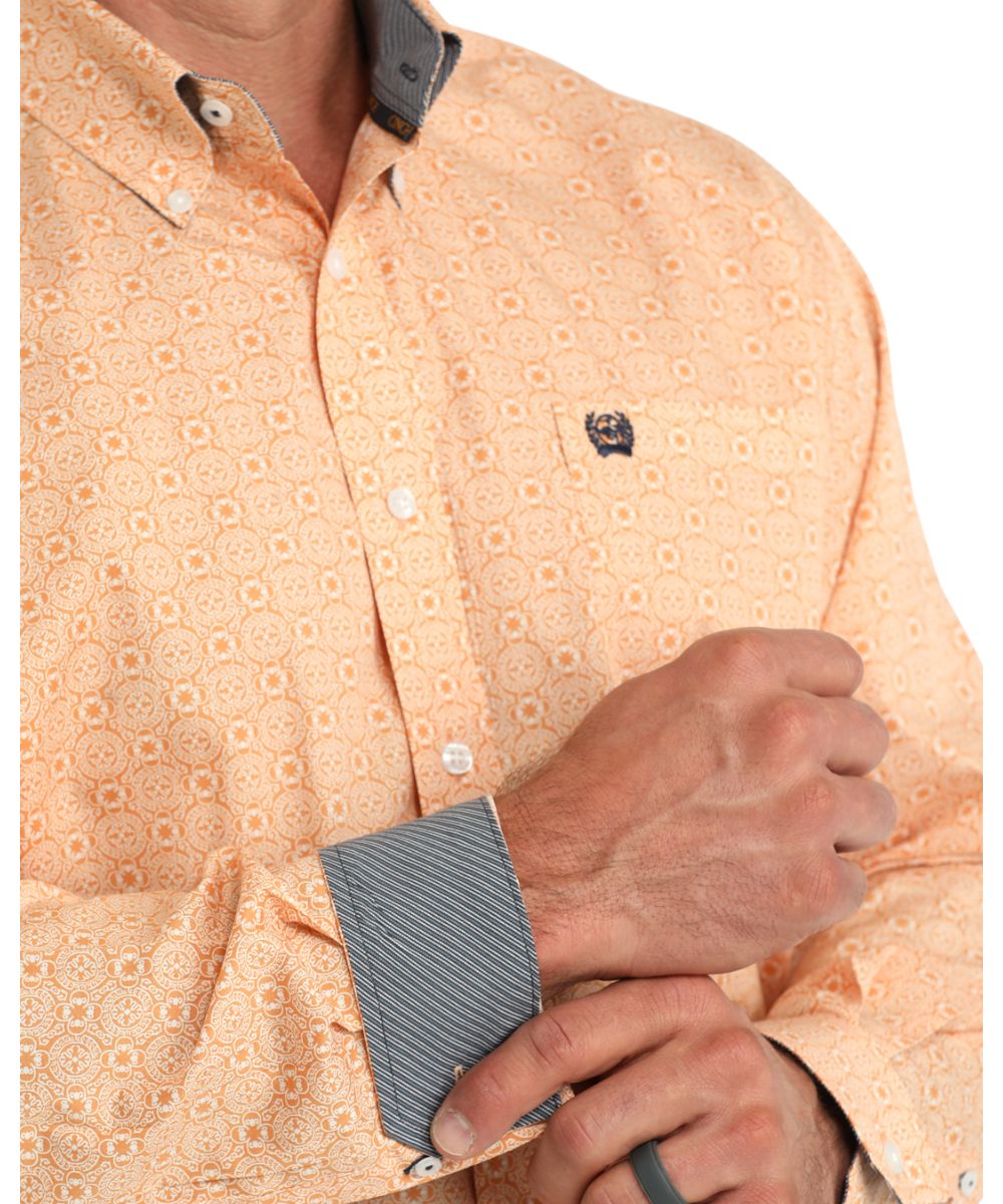 Close-up view of the geometric print, contrast interior trim, button down collar, and chest pocket