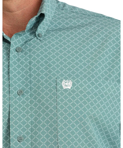 Close-up view of the white geometric print, single open chest pocket with Cinch logo embroidery, and button down collar