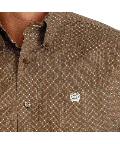 Close-up view of the white geometric print, brown buttons, and single open chest pocket with logo embroidery