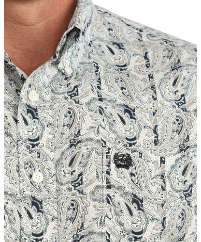 Close-up view of the men's cream long sleeve button down shirt featuring the striped and paisley print