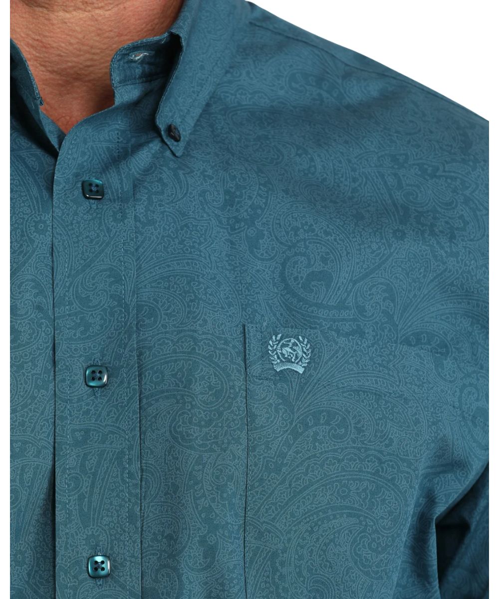 Close-up view of the men's blue long sleeve button down shirt featuring the paisley print and blue square buttons