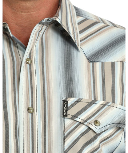 Close-up view of the multicolor striped print, western yokes, brown marble snaps, and the snap flap chest pockets with a logo label