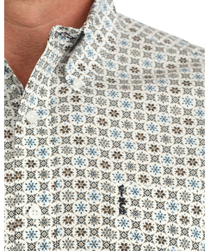 Close-up view of the geometric print, cream buttons, and chest pocket with logo embroidery