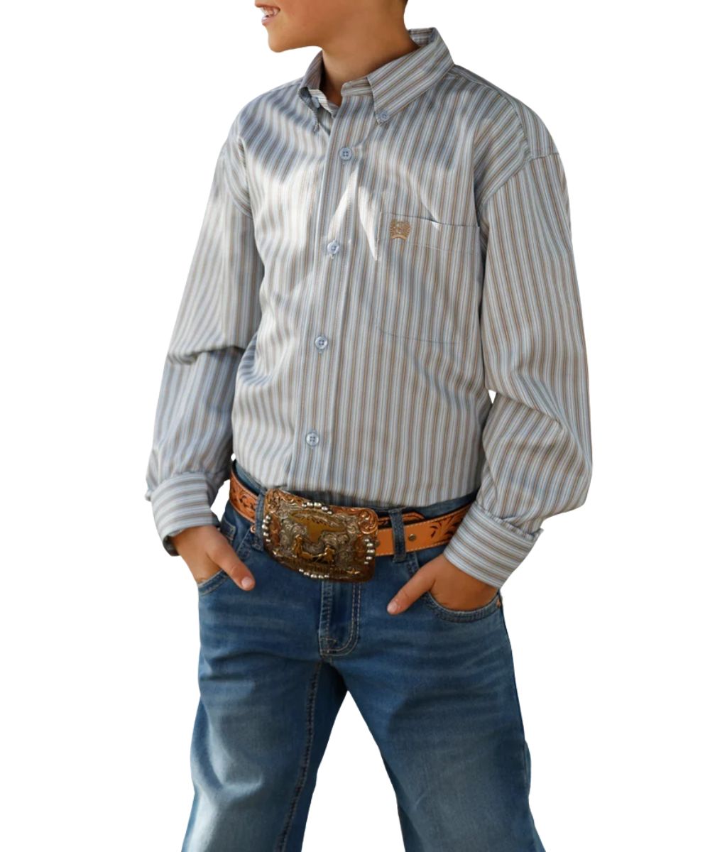 Front view of the boy's light blue Cinch long sleeve button down shirt featuring the button down collar, light blue buttons, vertical striped print, and a single open chest pocket with logo embroidery