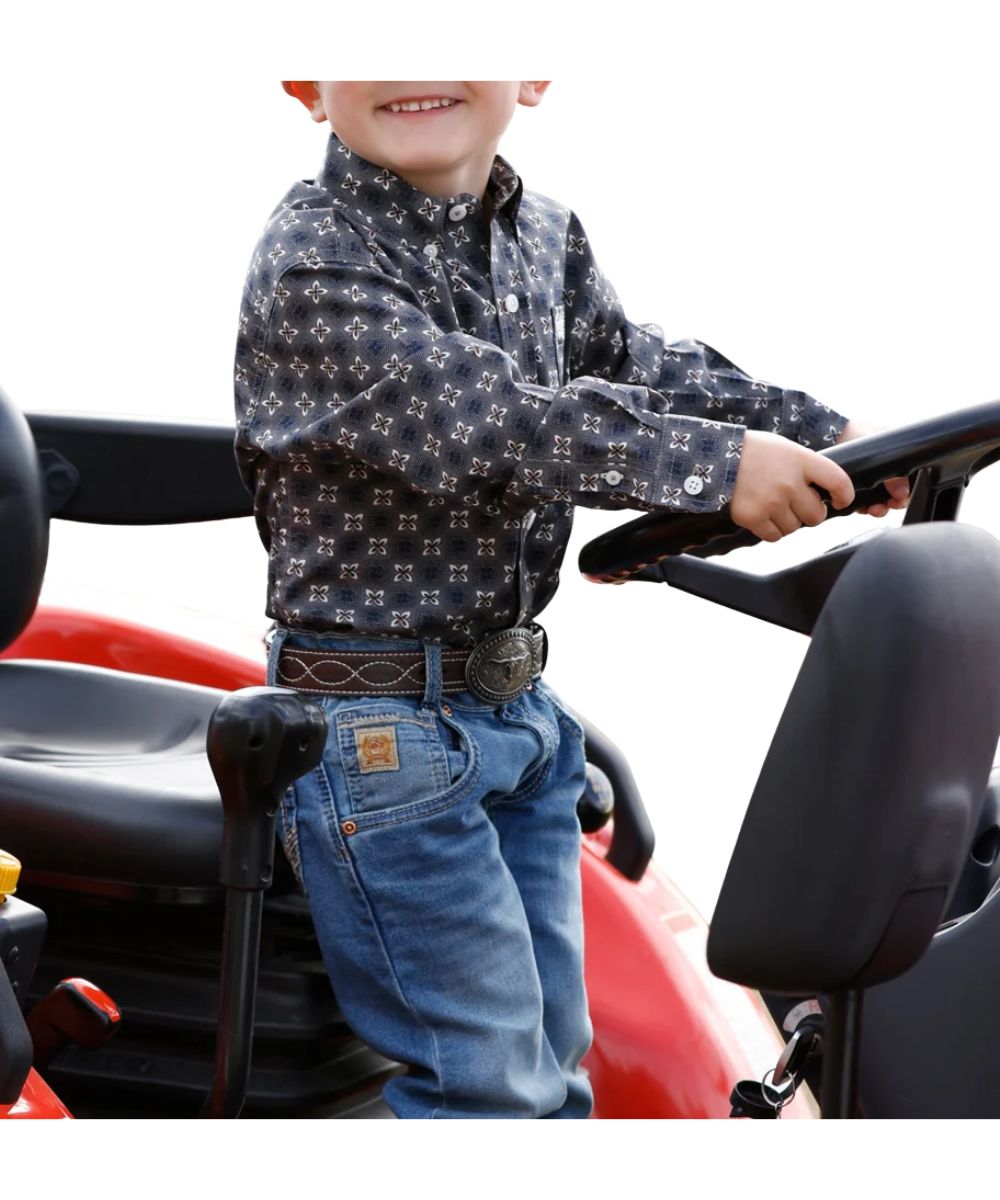 Side view of the toddler boy's grey Cinch long sleeve button down shirt featuring the khaki geometric print, button down collar, white buttons, and the single open chest pocket with logo embroidery