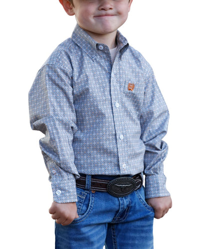 A young boy wearing a long-sleeve button-down shirt with a blue and white geometric pattern, paired with blue jeans and a black western belt, shown against a plain white background.