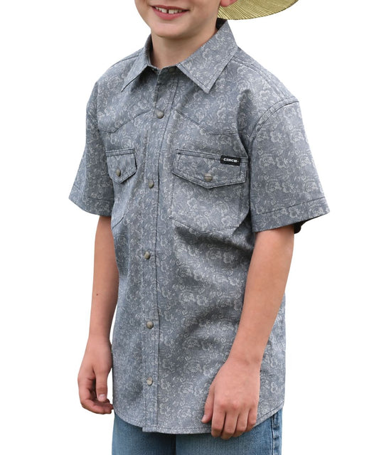Front view of the boy's short sleeve navy floral print snap shirt