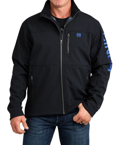Front view of the men's black Cinch bonded softshell jacket featuring the zipper closure, mock collar, long sleeves, zippered chest pockets, zippered hand pockets, and snap cuffs