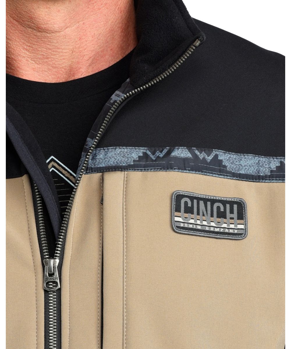 Close-up view of the woven logo label at the left chest and the durable water-resistant finish