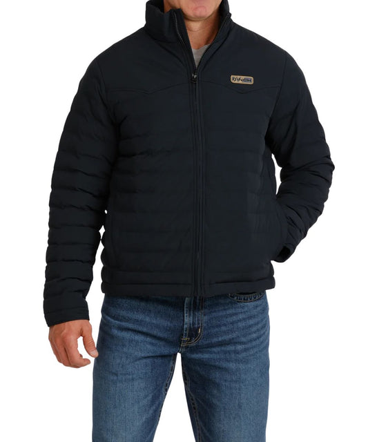 Front view of the men's black quilted Cinch Puffer Jacket featuring the zip-up closure, velcro cuffs, PrimaLoft Gold Insulation, and a durable water-resistant finish
