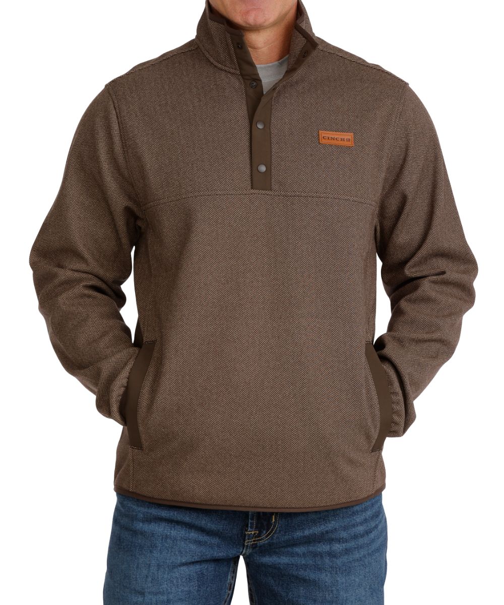 Front view of the men's brown Cinch pullover featuring the 1/4 snap placket, herringbone pattern, kangaroo pocket, contrast trim, and mock collar