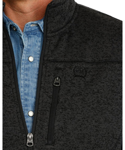 Close-up view of the charcoal sweater vest featuring the logo embroidery at the left chest