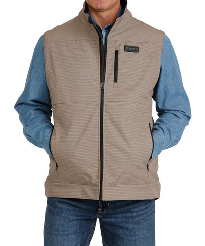 Front view of the men's khaki Cinch concealed carry vest featuring the mock collar, zip closure, zippered hand and chest pockets, and the durable water-resistant finish