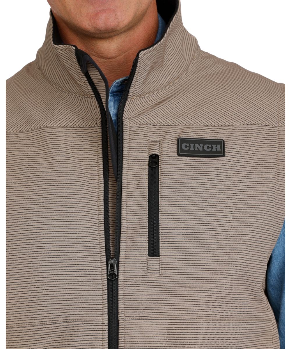 Close-up view of the zippered chest pocket and the horizontal lined print
