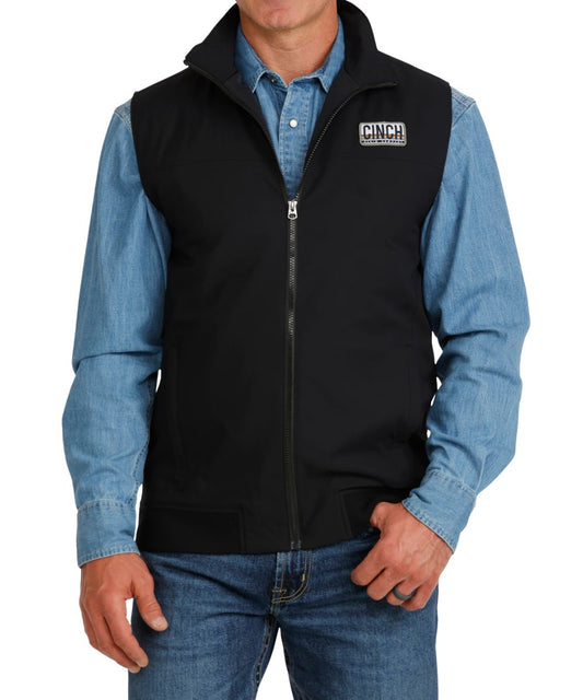 Front view of the men's black Cinch lightweight vest featuring the zip closure, mock collar, and zippered hand pockets
