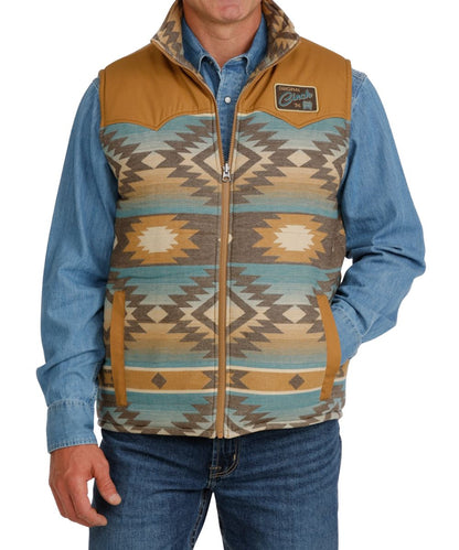 Front view of the men's blue serape Cinch Reversible Vest featuring the color blocked design (with solid tan yokes), western yokes, side entry hand pockets, mock collar, and zip closure