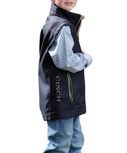 Side view of the boy's navy vest featuring the logo embroidery at the left chest and right lower side panel