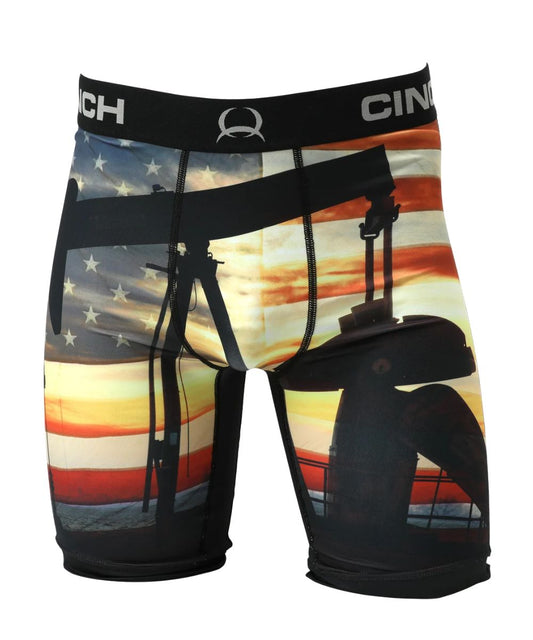 Front view of the men's pump jack 9" Cinch Boxer Briefs featuring the American Flag background with an oil pump jack silhouette