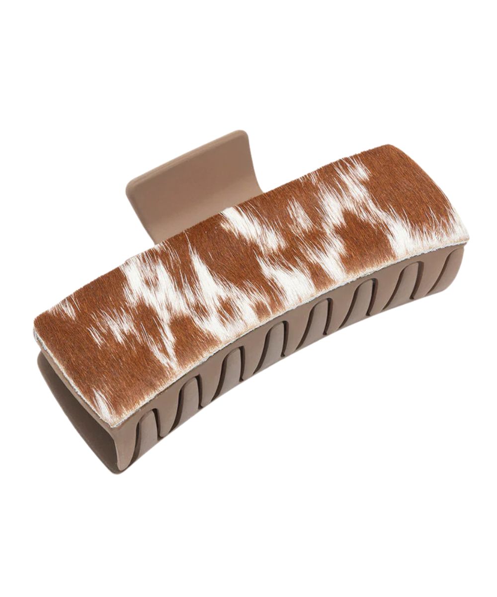 Sandstone plastic claw clip featuring brown and white hair-on-hide leather overlays.