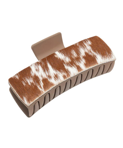 Sandstone plastic claw clip featuring brown and white hair-on-hide leather overlays.