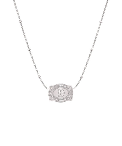 ultra mini silver belt buckle d initial necklace on white background 