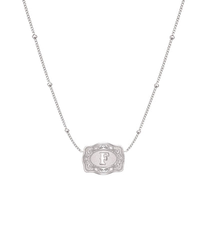 ultra mini silver belt buckle f initial necklace on white background