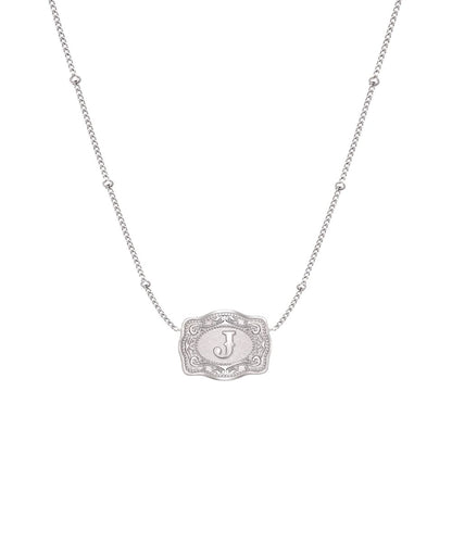 ultra mini silver belt buckle j initial necklace on white background