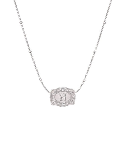 ultra mini silver mini belt buckle n initial necklace on white background