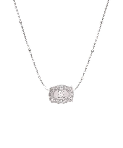 ultra mini silver belt buckle necklace r initial on white background