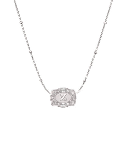 ultra mini silver belt buckle z initial necklace on white background 