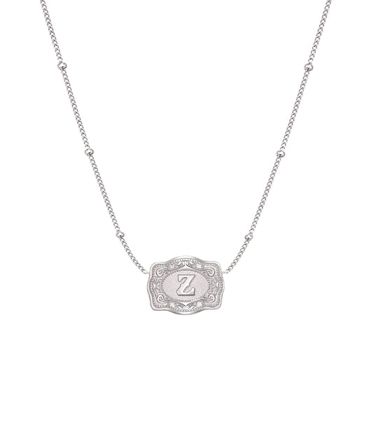 ultra mini silver belt buckle z initial necklace on white background 