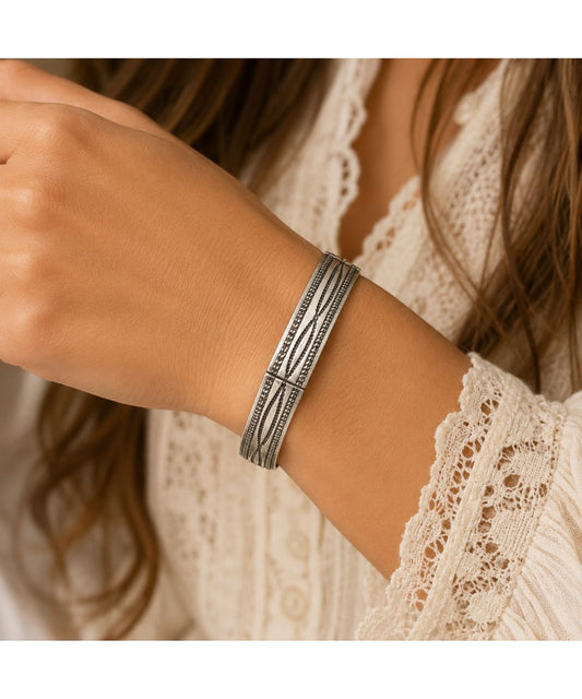 Model view of the women's silver tone western boot stitch engraved stretch bracelet