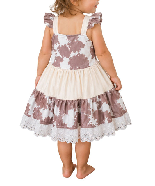 Back view of the girl's brown cow print ruffle dress
