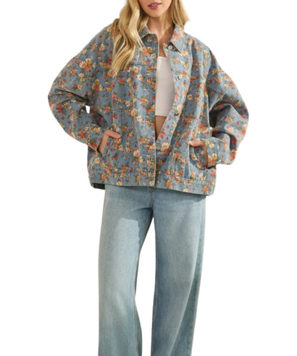 Women's relaxed fit, light wash denim trucker jacket featuring chest and hand pockets, button closure, and dropped shoulders.