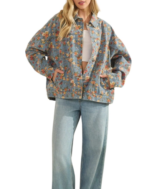 Women's relaxed fit, light wash denim trucker jacket featuring chest and hand pockets, button closure, and dropped shoulders.