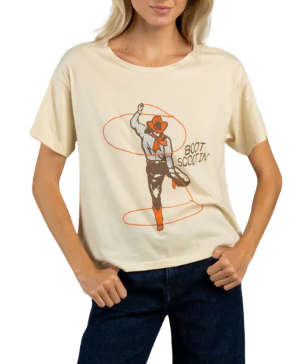Front view of the oversized women's citadel tee featuring a front screen print that reads: "Boot Scootin'" with a cowgirl lasso graphic 