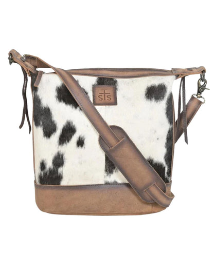 Front view of the women's brown STS Cowhide Mail Crossbody Bag featuring the hair-on-hide front, removable/adjustable crossbody strap, and the zip-top closure