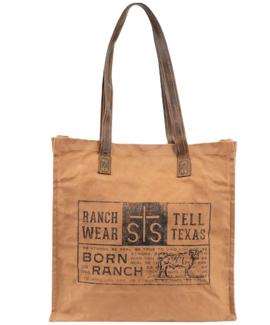Front view of the tan STS Ranch Surplus Small Tote featuring the assorted STS Ranchwear printed canvas and the dual leather shoulder straps
