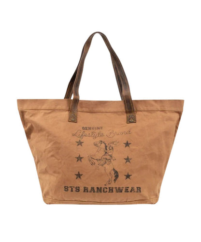 Front view of the tan canvas STS Ranch Surplus Large Tote featuring the assorted STS Ranchwear Printed canvas and the dual leather shoulder straps