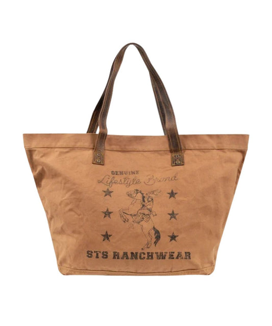 Front view of the tan canvas STS Ranch Surplus Large Tote featuring the assorted STS Ranchwear Printed canvas and the dual leather shoulder straps