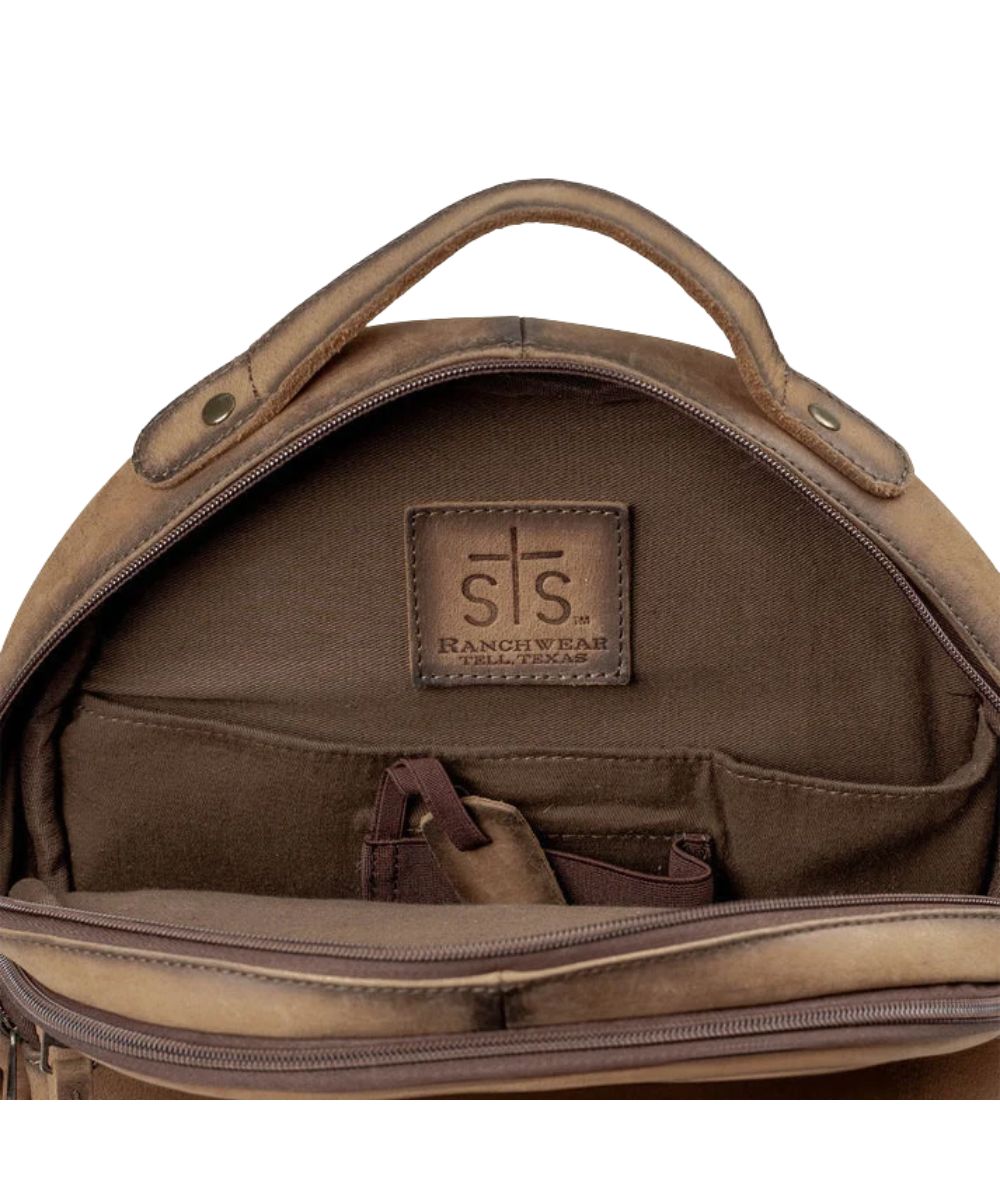 Interior view of the concealed carry pocket inside the brown leather backpack