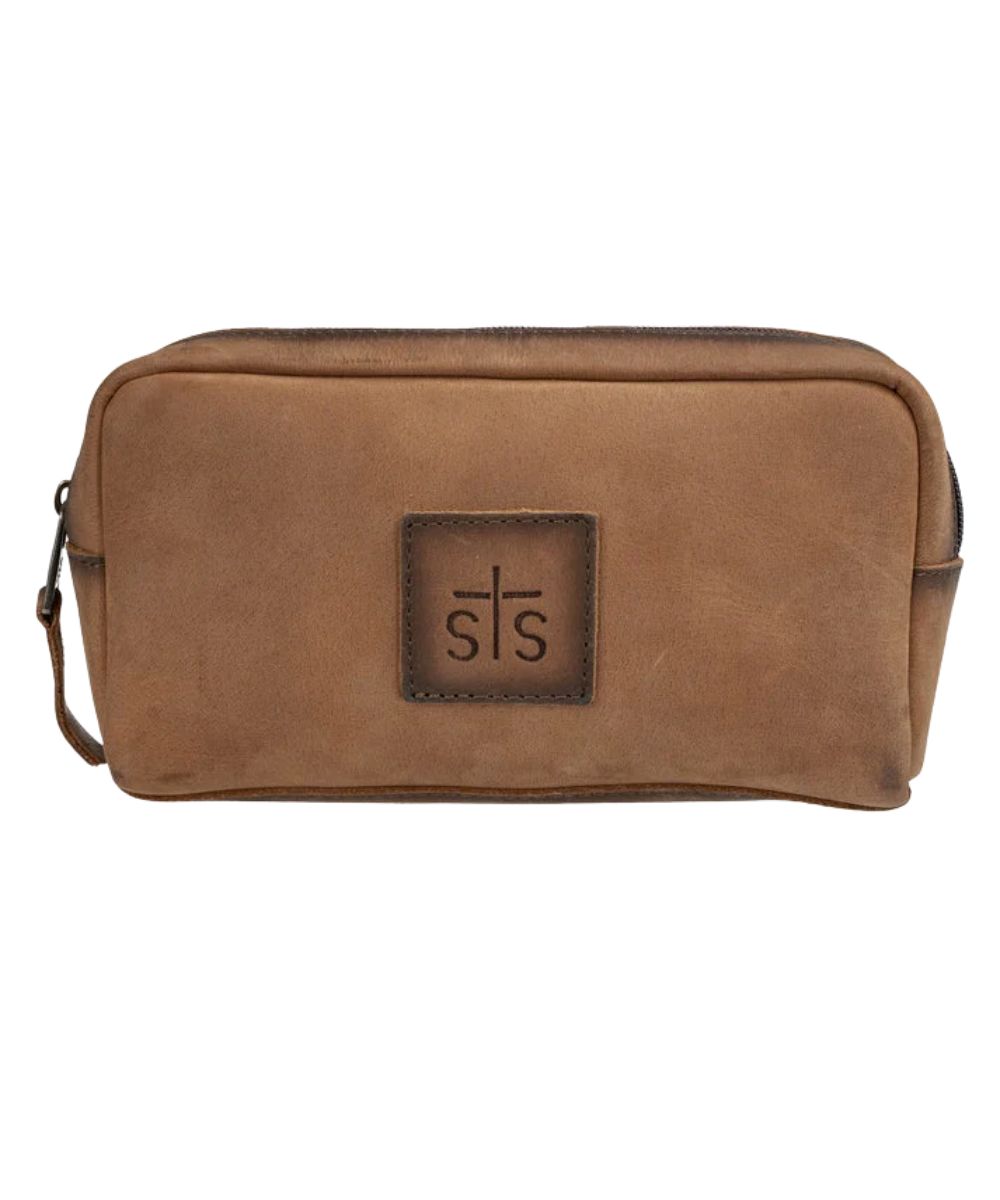 Front view of the brown STS Baroness Bebe Cosmetic bag featuring the STS logo patch and top zipper closure