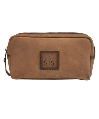 Front view of the brown STS Baroness Bebe Cosmetic bag featuring the STS logo patch and top zipper closure
