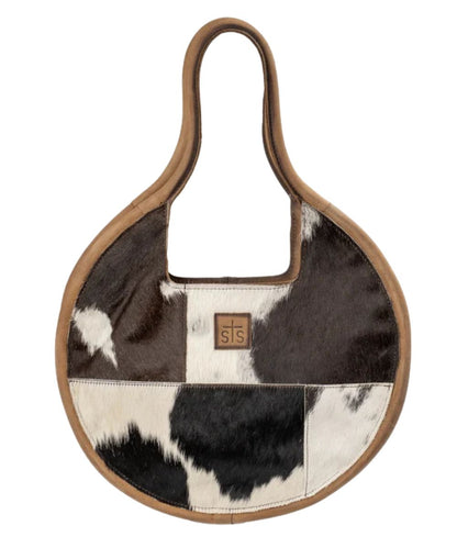 Front view of the women's brown STS Cowhide Dolly Purse featuring the hair-on-cowhide front with an STS leather patch, and dual rolled leather carry handles