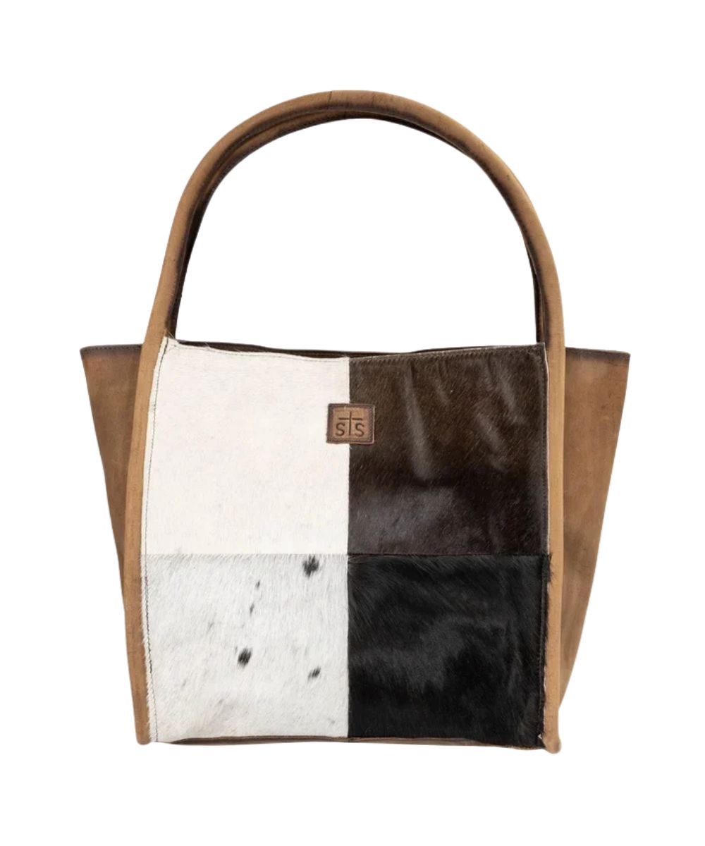 Front view of the women's brown STS Cowhide Betty Tote featuring the hair-on-hide leather front, the dual leather carry handles, and STS logo patch