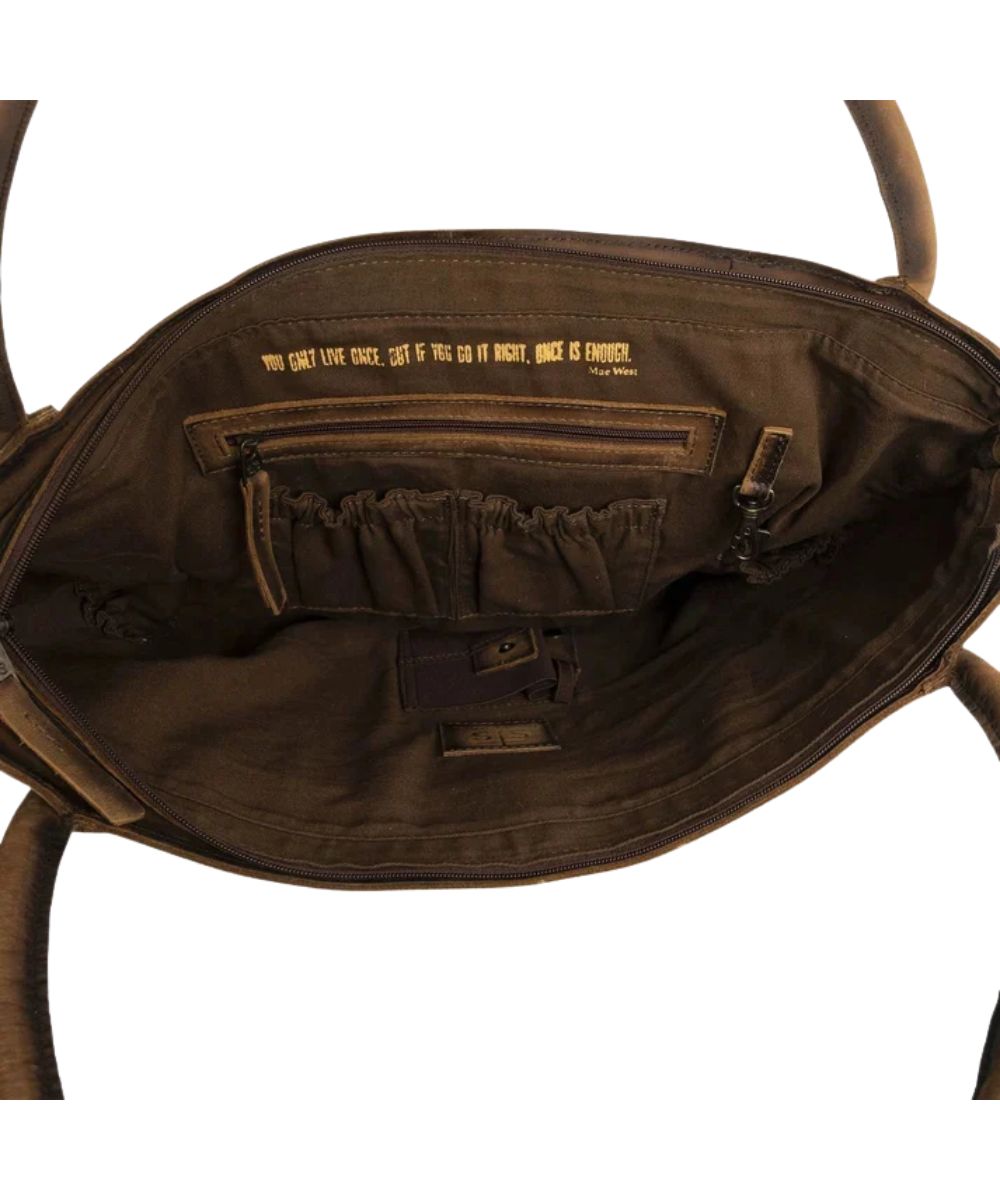Interior view of the women's cowhide tote featuring the interior zip and scrunch pockets, interior concealed carry pocket, and a quote inside that reads: "You Only Live Once, But If You Do It Right, Once Is Enough."