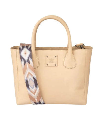 Front view of the women's beige STS Basic Bliss Buckskin Satchel Purse featuring the dual rolled leather carry handles, an STS stamped leather patch, and the removable printed nylon shoulder strap