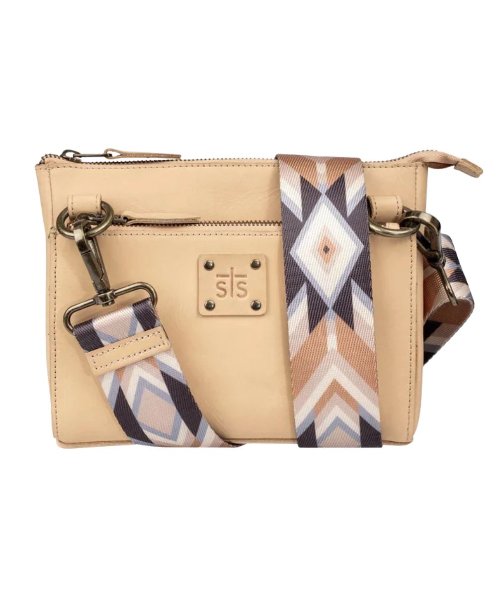 Front view of the women's beige Basic Bliss Buckskin Lily Crossbody featuring the printed nylon removable/adjustable crossbody strap, STS stamped leather patch, and zip closure