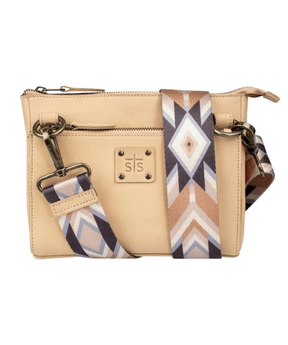 Front view of the women's beige Basic Bliss Buckskin Lily Crossbody featuring the printed nylon removable/adjustable crossbody strap, STS stamped leather patch, and zip closure