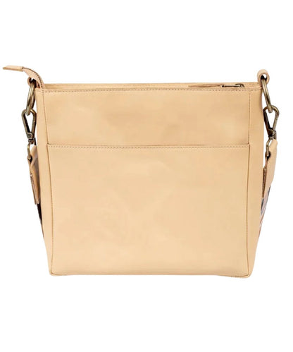 Back view of the women's beige leather crossbody featuring the back exterior slip pocket